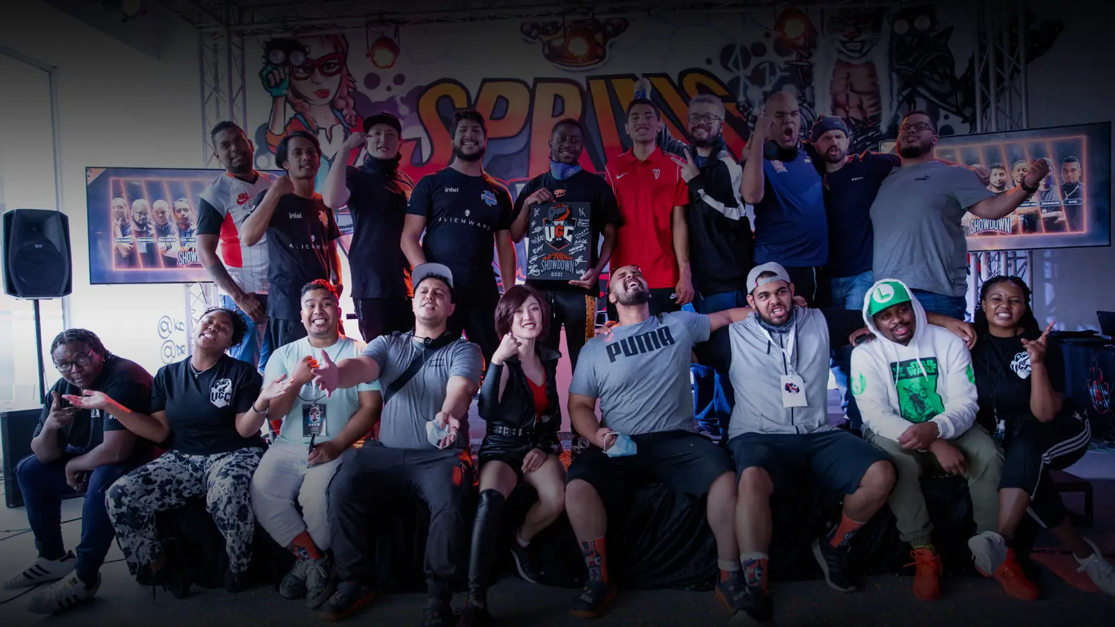 A Spring Showdown group photograph: competitors and staff assembled in front of event branding.